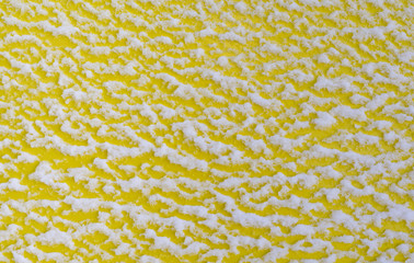 Snow on a yellow board.