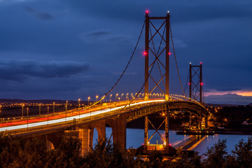 Firth of Forth Road Bridge Scotland at night with car trails