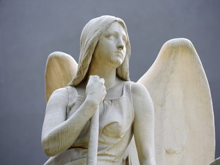 Cemetery sculpture Angel sitting detail upper body