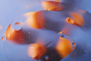 the texture of the background of the oil stains on the water circles yellow blue abstraction