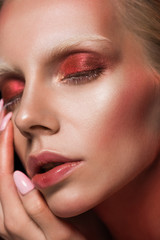 close up of attractive girl with closed eyes and red makeup for fashion shoot