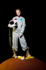 beautiful female cosmonaut posing in spacesuit with flowers and helmet on mars © LIGHTFIELD STUDIOS