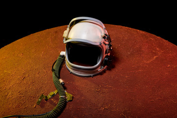 helmet from spacesuit lying on red planet in black cosmos © LIGHTFIELD STUDIOS