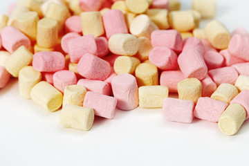 Background from  yellow and pink zephyr. Small candy marshmallow. Sweet food fon with copy space.