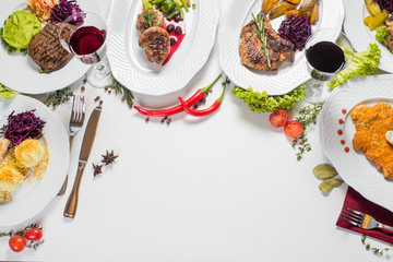 Different meat dishes with vegetables and spices. Top view. Flatlay. Copy space