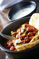 Tortilla with chili pork and sour cream sauce 