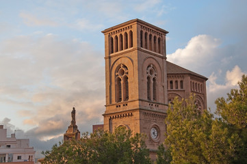 Church with tower and Holy Mary statue