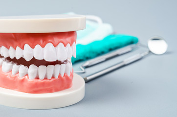 Fototapeta na wymiar White teeth and dental instruments.