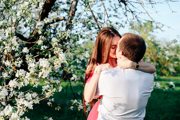 a young couple in love in the spring flowering Park