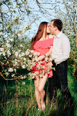 a young couple in love in the spring flowering Park