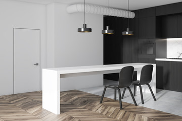 White and black kitchen corner in a studio flat