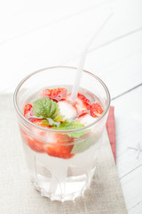 Strawberry detox water, slice fruit, glass.