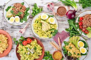 A set of food from buckwheat, bulgur and pasta. On a wooden background. Top view. Copy space.