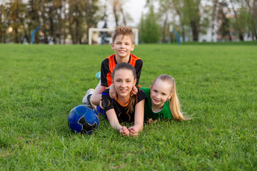 Fototapeta premium Family playing football on the field. Family football