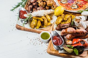 Big set of different dishes with meat, vegetables, pizza and spices flatlay on white background