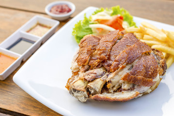 German pork knuckle hocks or Gebratene Schweinehaxe with several sauces and fried potatoes delicious Thai food.