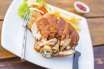 German pork knuckle hocks or Gebratene Schweinehaxe with several sauces and fried potatoes delicious Thai food.