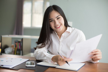 Beautiful young Asia woman working in office