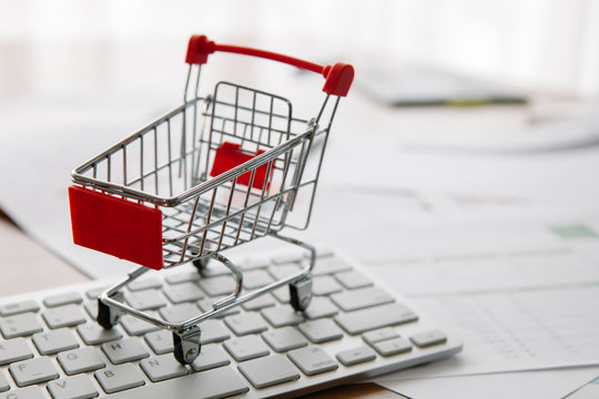 Shopping Cart On A Laptop Keyboard. Ideas About E-commerce, E-commerce Or Electronic Commerce Is A Transaction Of Buying Or Selling Goods Or Services Online Over The Internet.