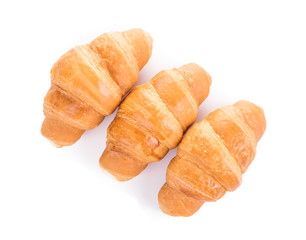Three fresh croissants isolated over white background