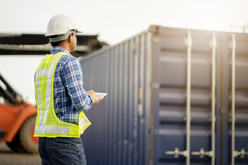 Young engineer use tablet  at warehouse site.