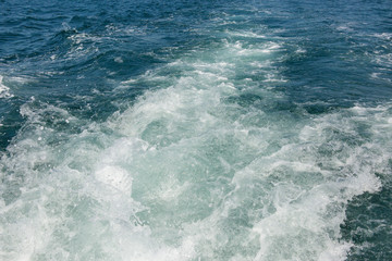 Fototapeta na wymiar Sea waves splashing, yacht track