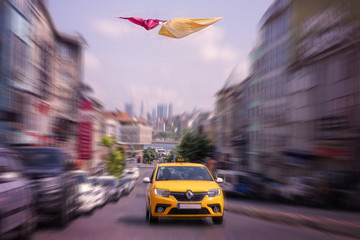 Istanbul, Turkey, June 13, 2018.  Yellow taxi car rushes down the street
