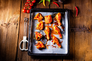 Rustic backed chicken wings,legs on baking tray