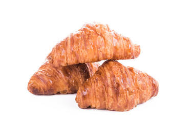 Three fresh croissants isolated over white background