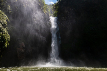 A 60m waterfall in a deep valley surrounded by rainforest (Tappiya Falls)