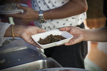 Rich people give food to the poor. starvation concept