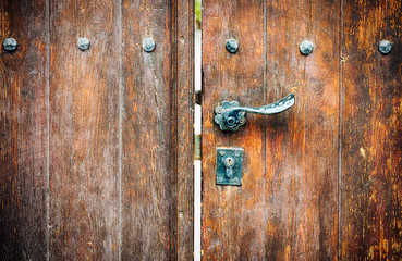 Wooden gate with door knob and keyhole.