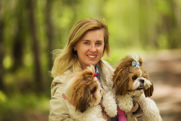 Portrait of a woman with her beautiful dogs outdoors