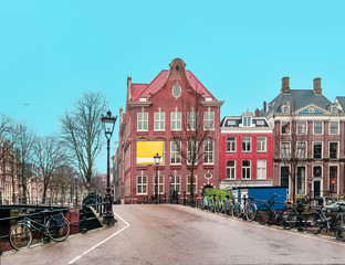 Empty streets of Amsterdam. Quarantine. Coronavirus concept. Traditional dutch old houses and bridges on canals in Amsterdam, Netherlands
