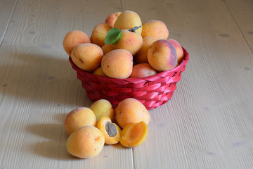 Season fuits/ basket of apricots with externally a pair of fruits cut in two parts
