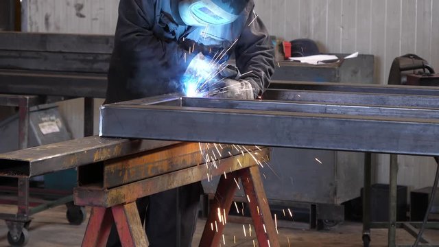Welder at work in metal industry, slow motion