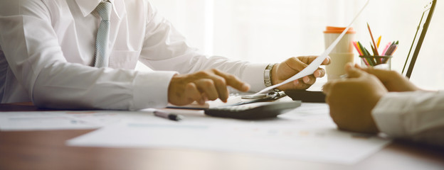 businessmen discussing project in laptop at meeting