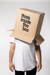 Man with box on his head, think inside the box