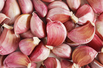 Pattern of fresh garlic lobules, top view. Food background, texture.