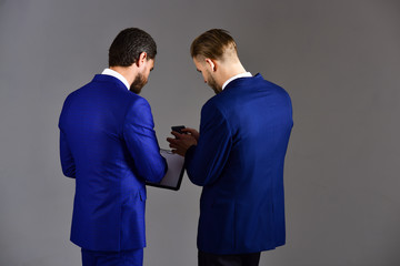 Information leak concept. Businessmen looks at secret document.