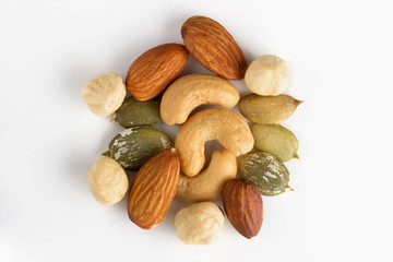 mixed nuts and seeds on white background close up