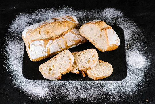 Sweet french bread on blavk wooden background