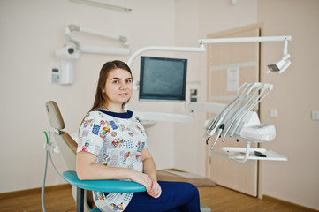 Portrait of baby dentist female at her dental office.