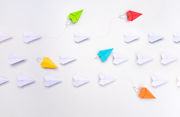 Group of paper planes in one direction and with one group individual pointing in the different way. Business for innovative solution concept.