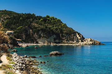 Idyllic sunny day on the rocky shore of north west coast of Lefkada island, Greece