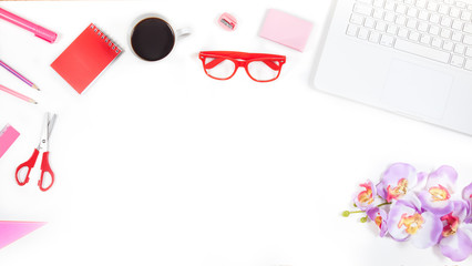 Office desk table with keyboard, notebook, pen, cup of coffee and flower