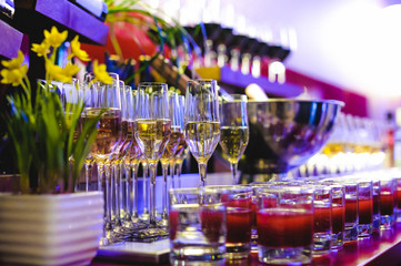 BANQUET reception beautifully served table with a variety of snacks and drinks. glasses of champagne with bubbles, bottle alcoholic drink in ice