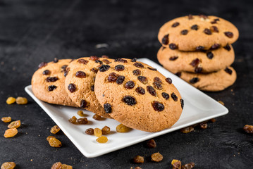Cookies with raisins on black background