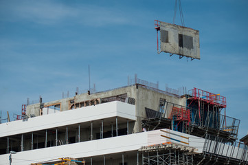 crane removing formwork elements on a building under construction