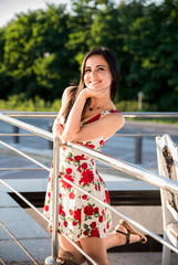 Beautiful brunette girl posing at restaurant terrace .